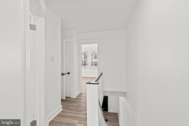 corridor with light hardwood / wood-style floors