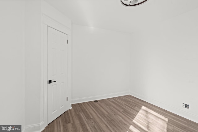 spare room with hardwood / wood-style floors