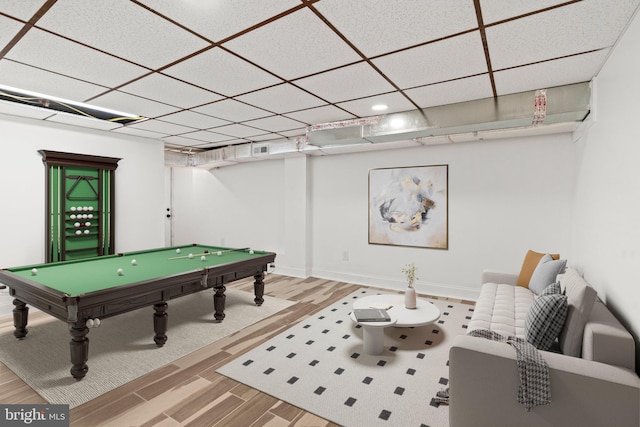 game room with a drop ceiling, hardwood / wood-style flooring, and pool table