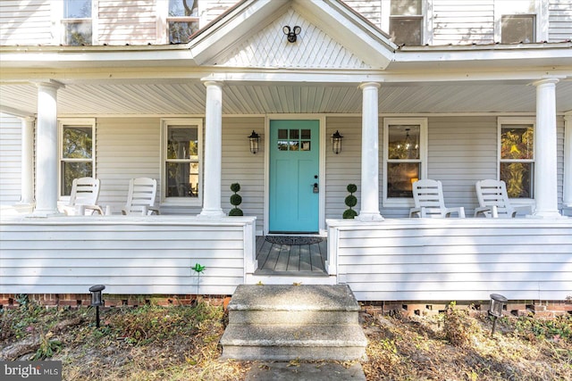 view of exterior entry featuring a porch