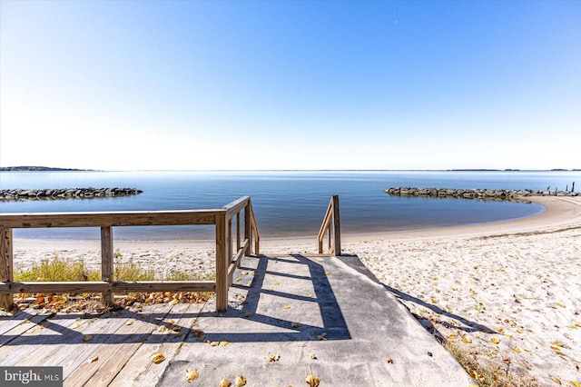 exterior space featuring a water view and a beach view