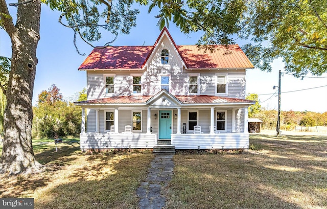 view of front of property with a porch and a front yard