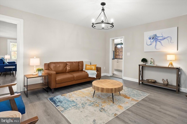 living room featuring dark wood-type flooring and a chandelier