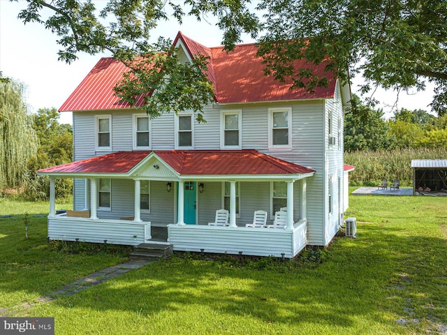 view of front of property featuring central AC unit, covered porch, and a front lawn