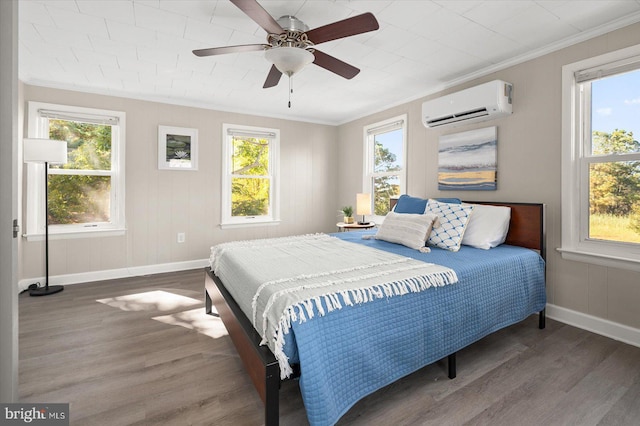 bedroom with ceiling fan, ornamental molding, dark hardwood / wood-style floors, and a wall mounted AC