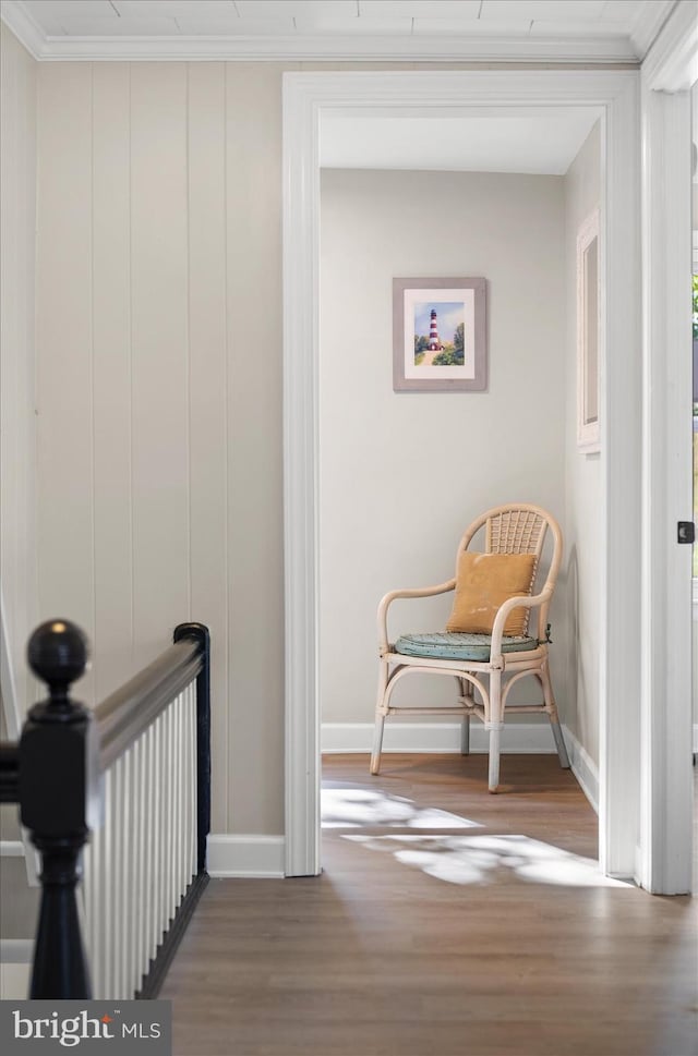 hallway featuring hardwood / wood-style floors and crown molding