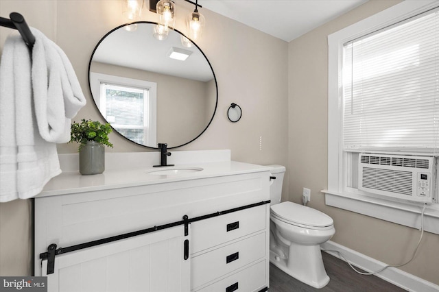 bathroom featuring cooling unit, vanity, toilet, and wood-type flooring