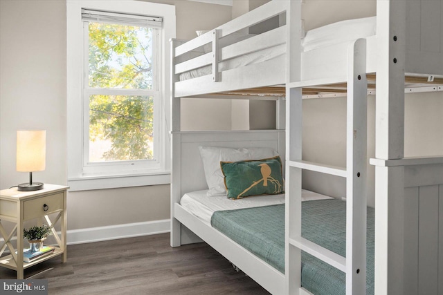 bedroom featuring dark hardwood / wood-style flooring and multiple windows