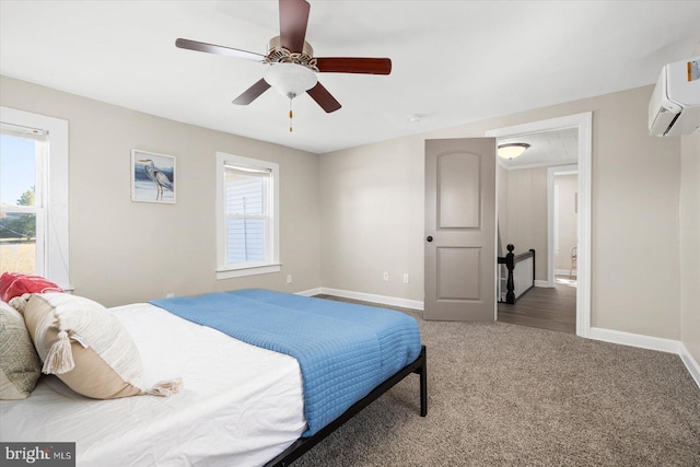 carpeted bedroom featuring ceiling fan and a wall mounted AC