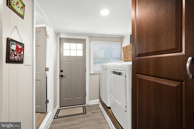 laundry room featuring washer and dryer and light hardwood / wood-style flooring