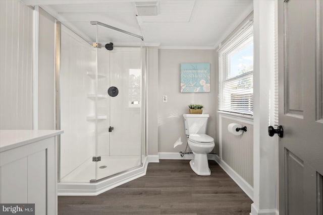 bathroom featuring toilet, an enclosed shower, crown molding, vanity, and hardwood / wood-style floors