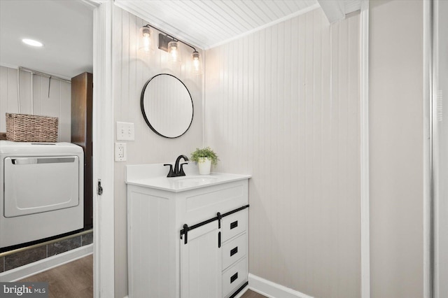 bathroom featuring washer / clothes dryer, vanity, and wood-type flooring