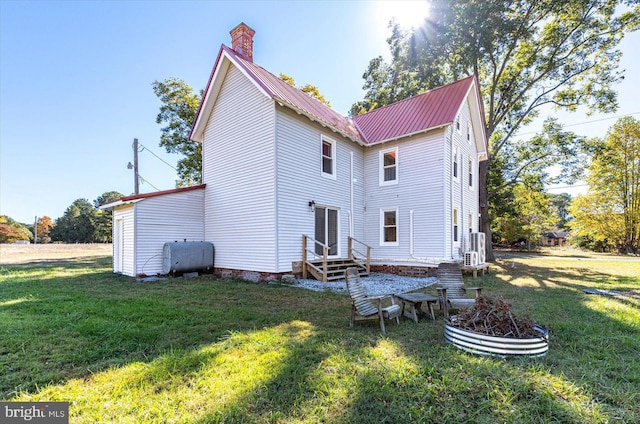 rear view of house featuring a yard