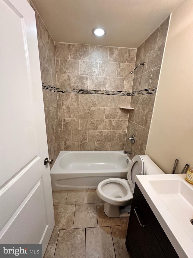 full bathroom featuring vanity, toilet, and tiled shower / bath combo