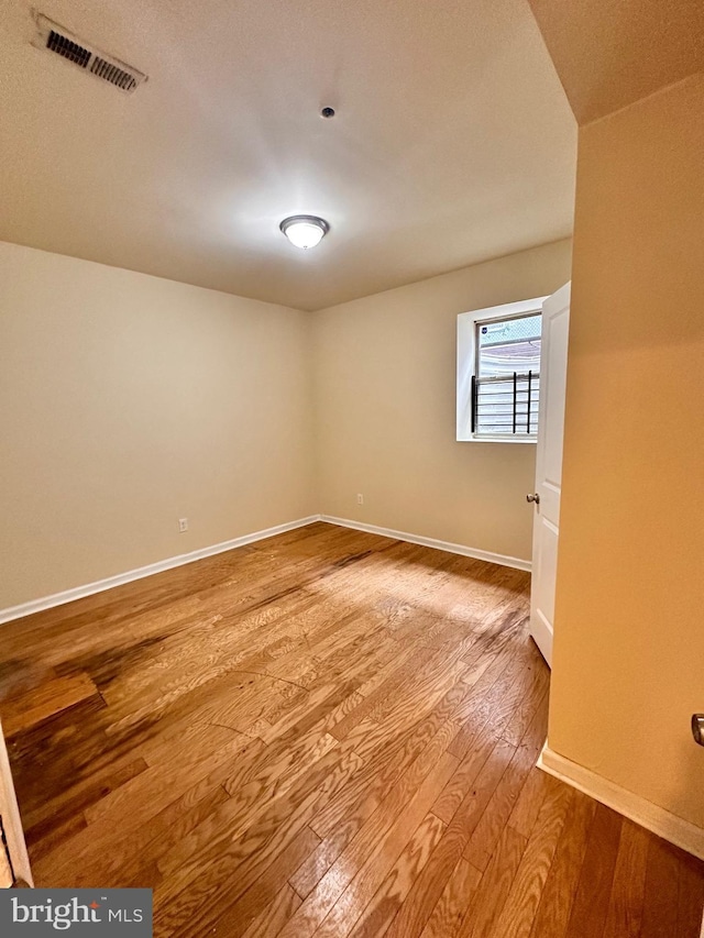 empty room with light hardwood / wood-style flooring