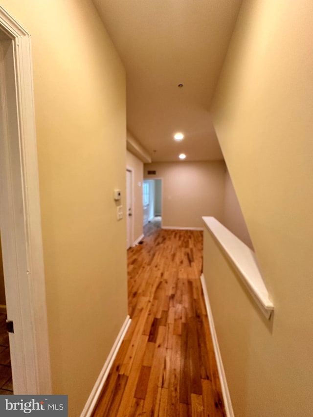 corridor with hardwood / wood-style floors