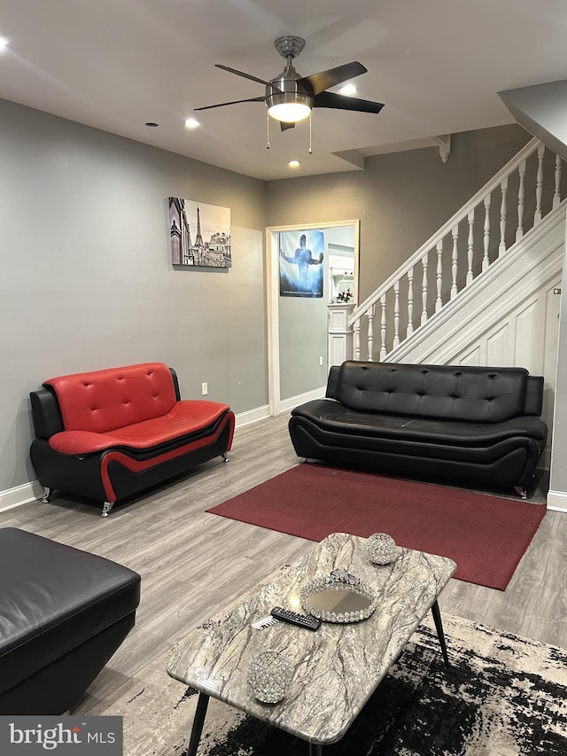 living room featuring hardwood / wood-style floors and ceiling fan