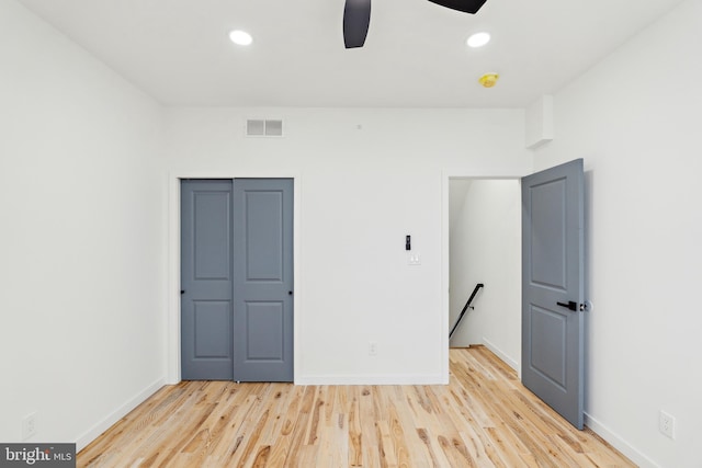 unfurnished bedroom with light hardwood / wood-style floors, a closet, and ceiling fan