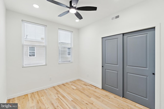 unfurnished bedroom with ceiling fan, hardwood / wood-style floors, and a closet