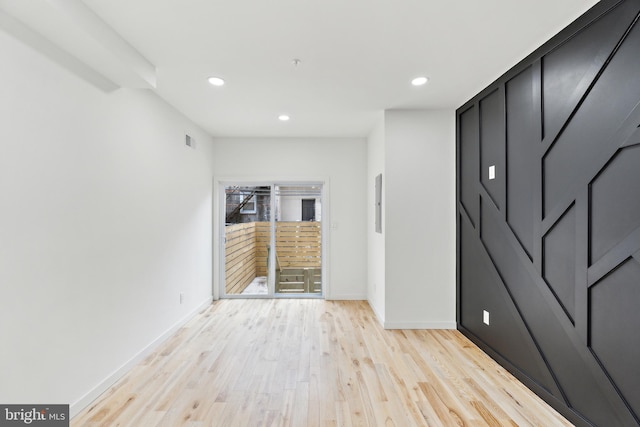 empty room with light hardwood / wood-style floors