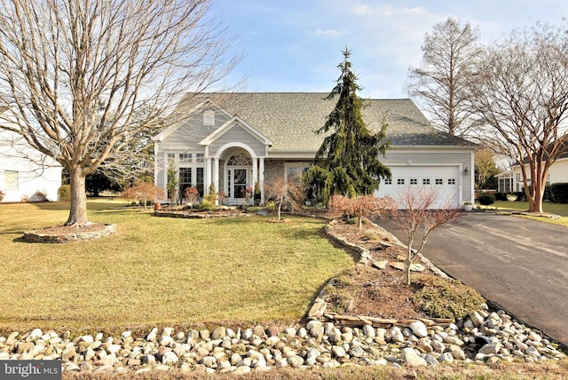 view of front of house featuring a garage and a front lawn