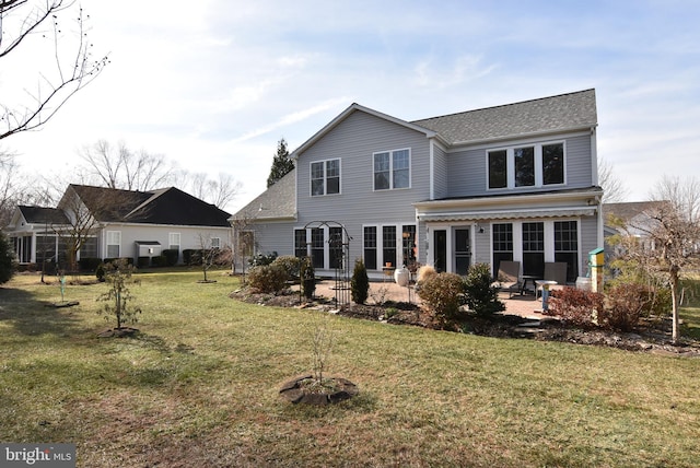 rear view of property with a lawn and a patio area