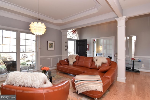 living room with ornamental molding, light wood-type flooring, and ornate columns