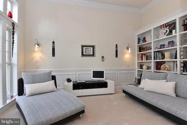 sitting room featuring crown molding and carpet