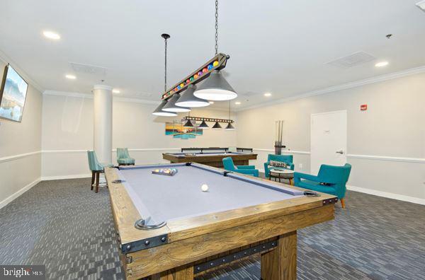 game room featuring billiards, ornamental molding, and dark carpet