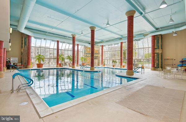 view of swimming pool featuring a lanai and a patio