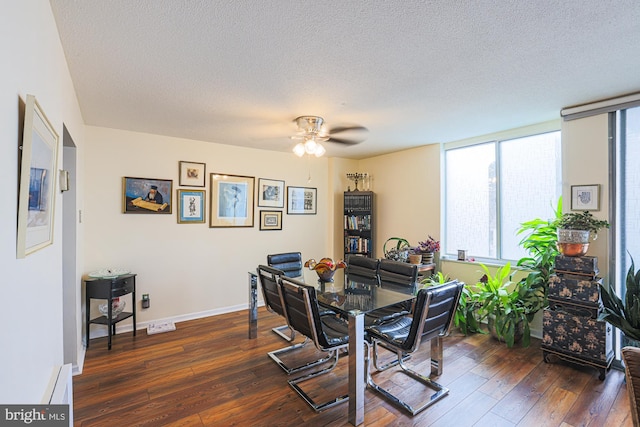 dining room featuring dark wood-type flooring, ceiling fan, a baseboard radiator, and a textured ceiling