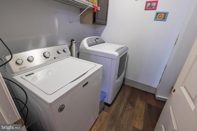 clothes washing area with dark wood-type flooring and washer and dryer