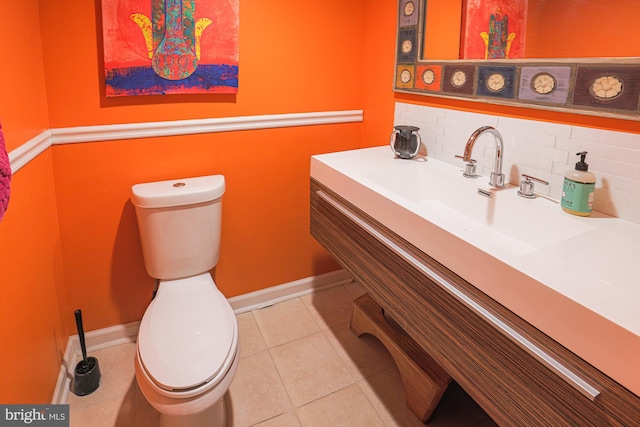 bathroom featuring vanity, toilet, tile patterned flooring, and backsplash