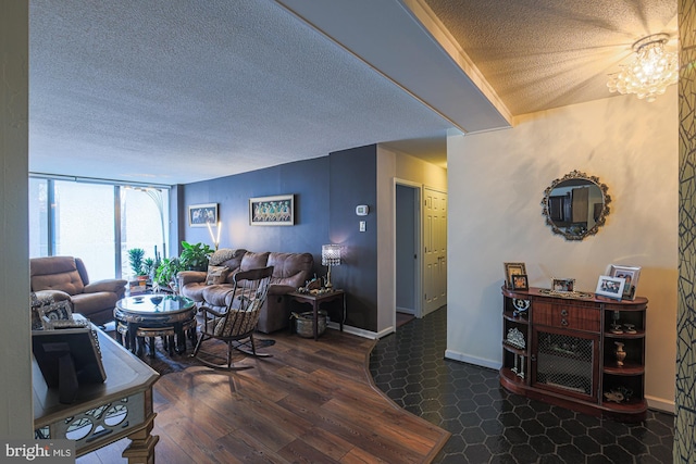 living room with a chandelier, dark hardwood / wood-style floors, and a textured ceiling