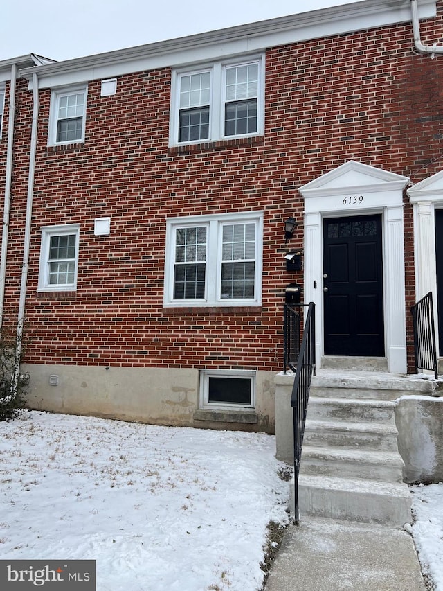 view of snow covered property entrance