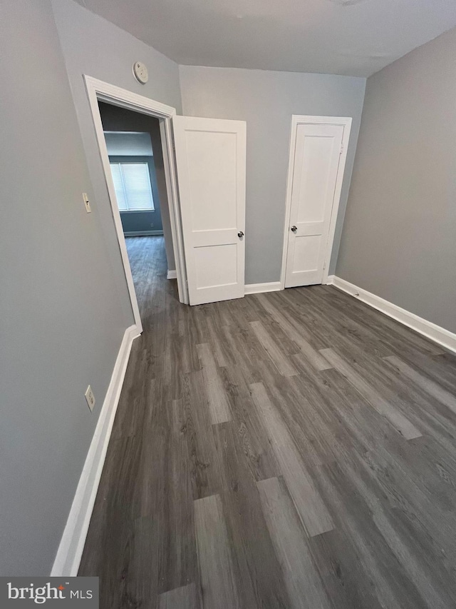 unfurnished room featuring dark hardwood / wood-style flooring