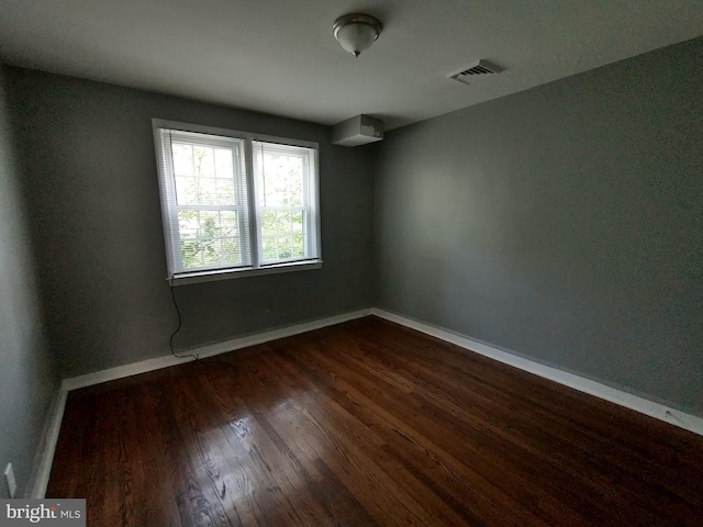 empty room featuring dark hardwood / wood-style flooring