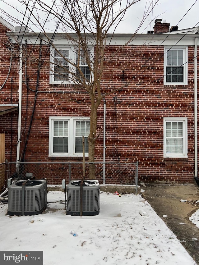 snow covered house with cooling unit