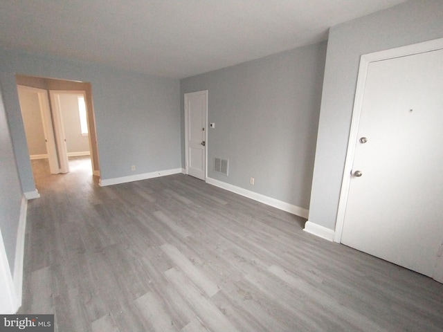 empty room with hardwood / wood-style flooring