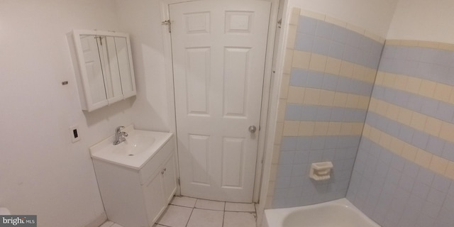 bathroom featuring tile patterned flooring, vanity, and a bathtub