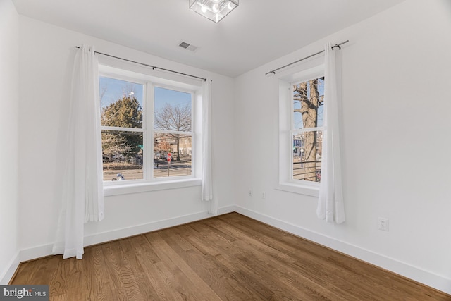 unfurnished dining area featuring hardwood / wood-style flooring and a healthy amount of sunlight