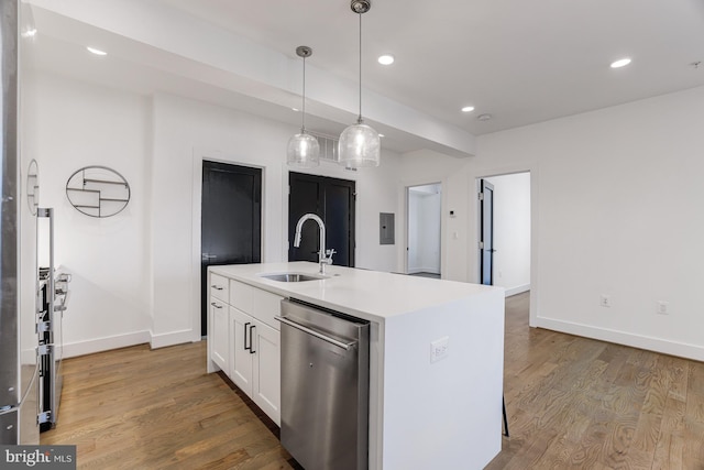 kitchen featuring sink, a center island with sink, pendant lighting, hardwood / wood-style floors, and white cabinets