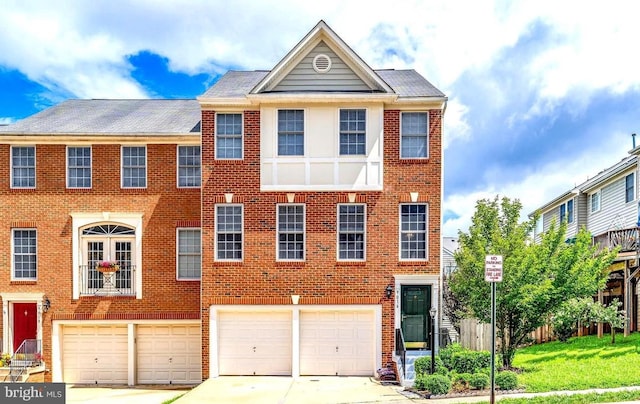 multi unit property featuring a garage and a front lawn