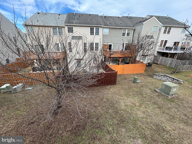 rear view of house featuring a yard