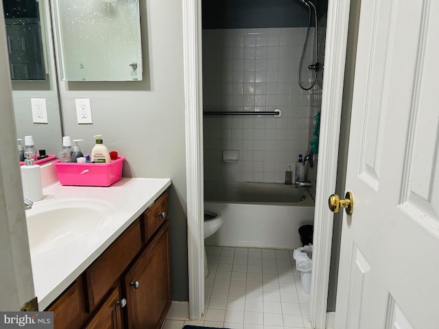 full bathroom featuring vanity, tile patterned flooring, tiled shower / bath combo, and toilet