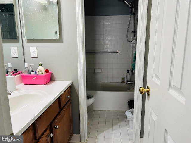 full bathroom featuring vanity, tiled shower / bath combo, tile patterned floors, and toilet