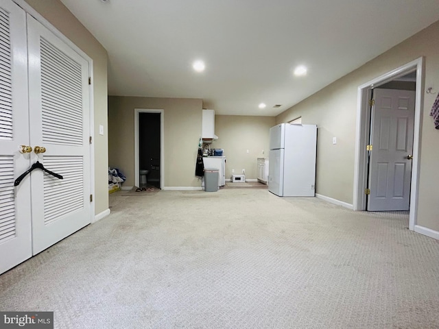 interior space with white refrigerator, light colored carpet, and washer / clothes dryer