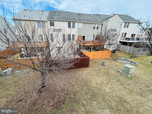 rear view of property featuring a lawn