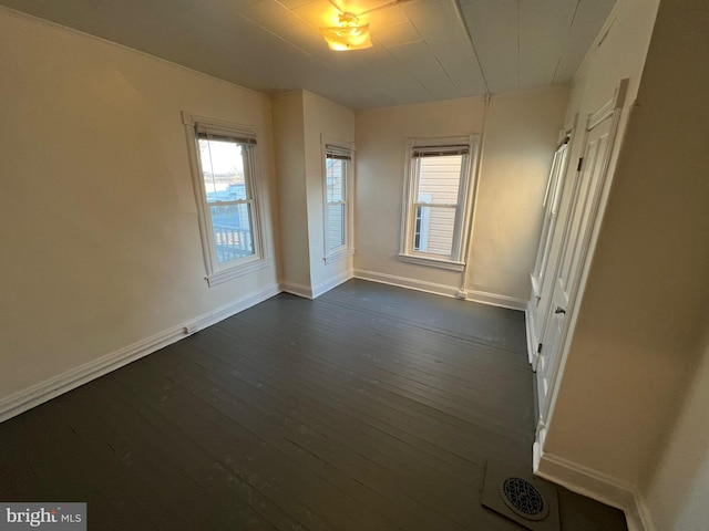 spare room featuring dark wood-type flooring