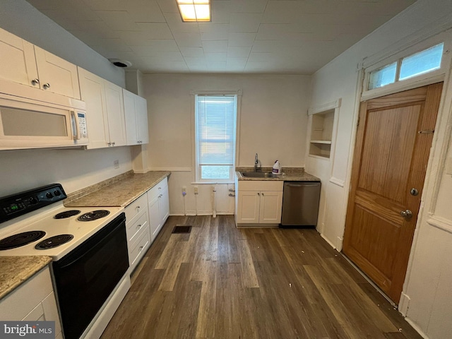 kitchen with electric range oven, sink, white cabinets, and dishwasher